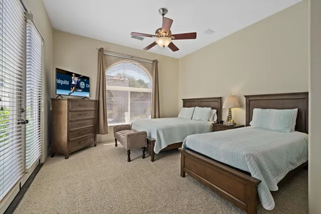 a bedroom with bed and a large window