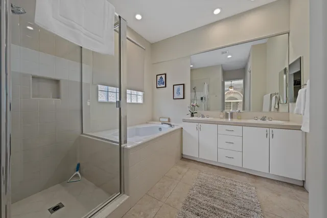 a spacious bathroom with a shower sink and mirror