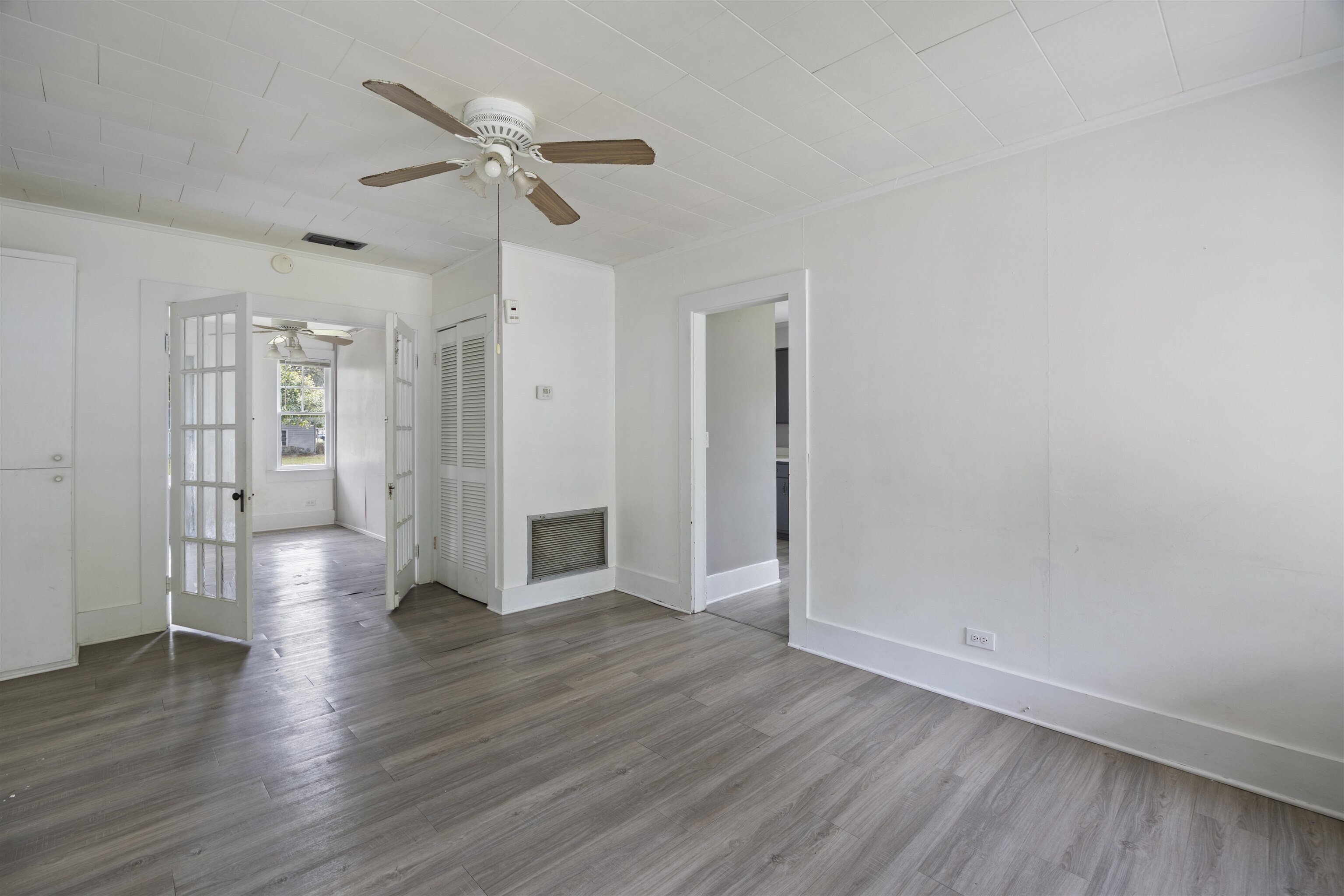 112 South Juniper Street Foley, AL 36535 - Photo 39 of 64 Unfurnished living room featuring ceiling fan, dark wood-type flooring, a fireplace, and crown molding