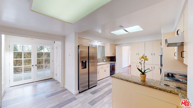 a bathroom with a granite countertop sink a mirror and a shower