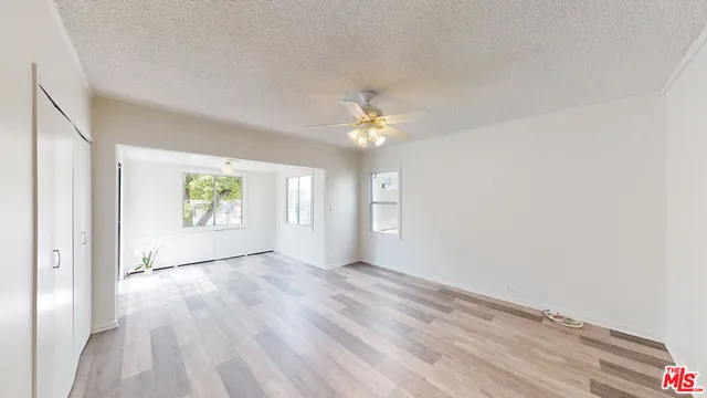 a view of a room with wooden floor and a window
