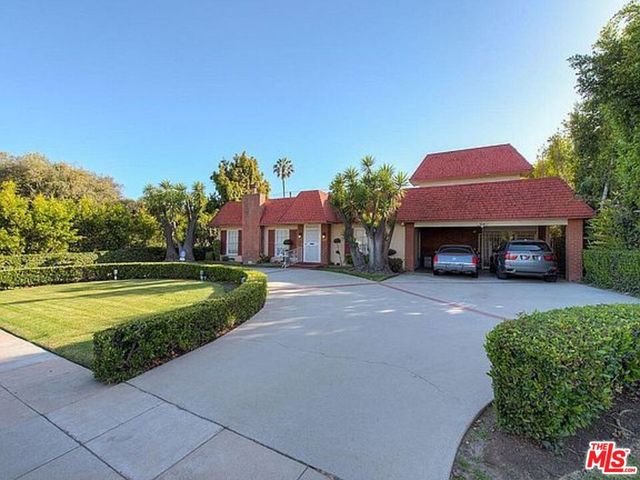a view of a swimming pool with a patio and a yard