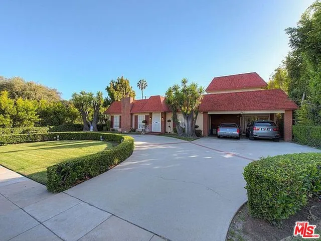 a view of a swimming pool with a patio and a yard