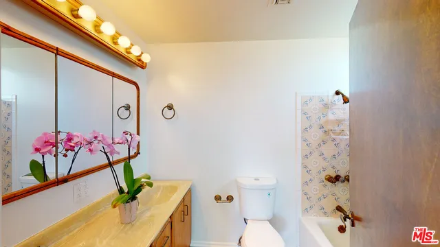 an aerial view of a house with a swimming pool and outdoor seating