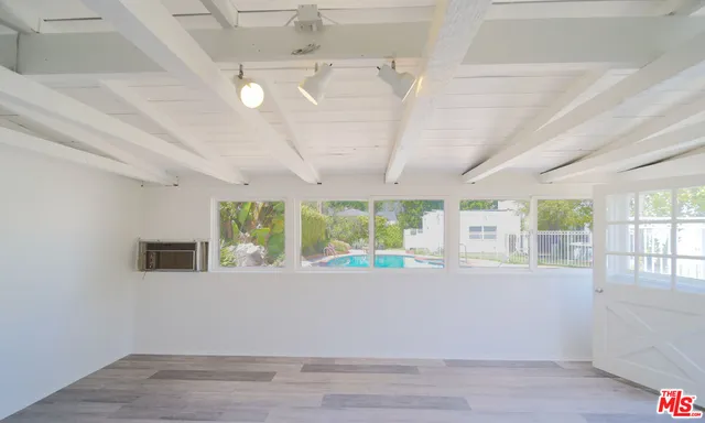 a view of a house with a small yard and wooden fence