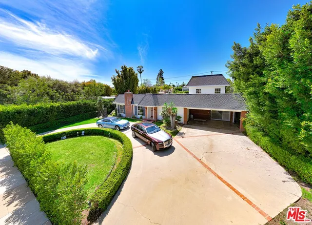 a view of a kitchen with a fridge and wooden floor