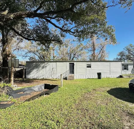 a backyard of a house with table and chairs