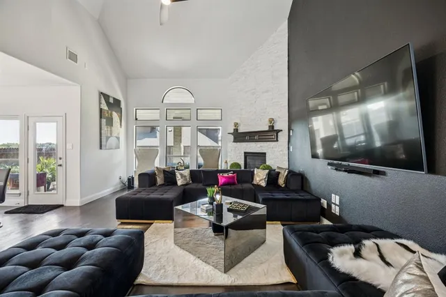 a living room with furniture fireplace and rug
