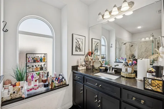a room with granite countertop a refrigerator and a sink
