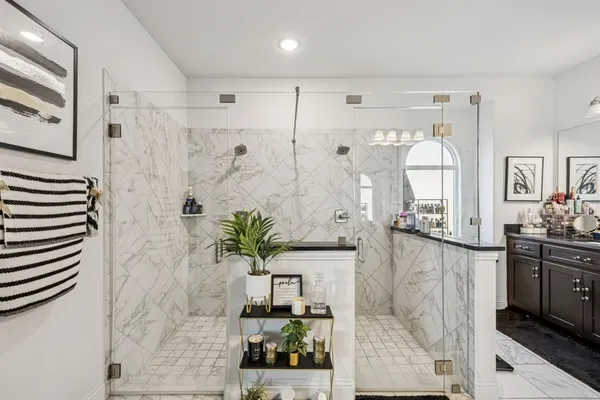 a bathroom with a potted plant and a shower