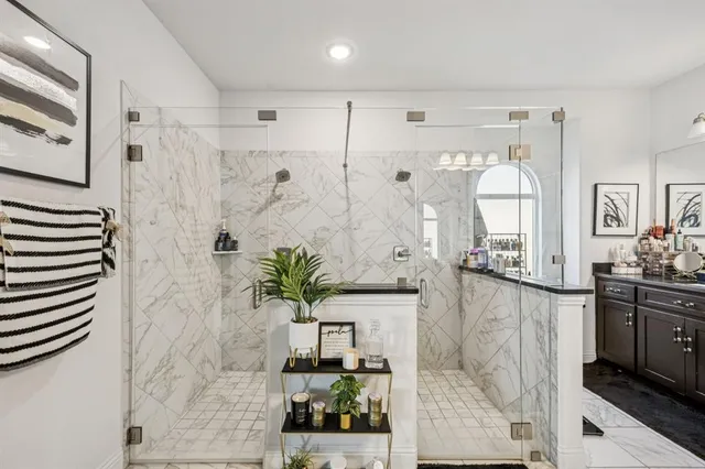 a bathroom with a potted plant and a shower