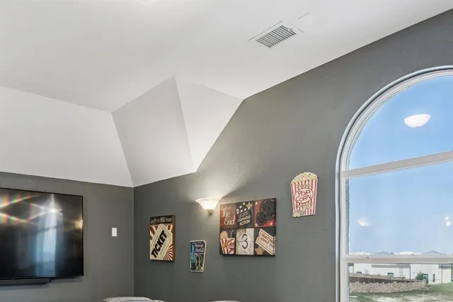 a view of a hallway with paintings on the wall