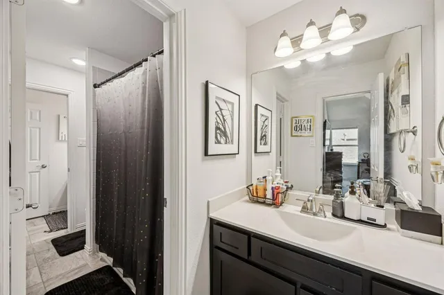 a bathroom with a sink vanity and a mirror