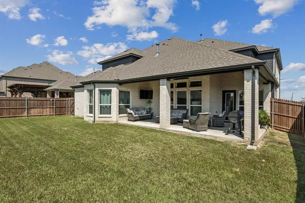 a house view with a sitting space and garden space