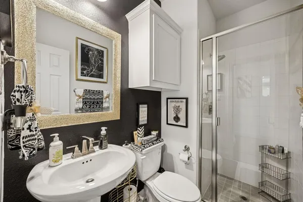 a bathroom with a sink toilet and shower