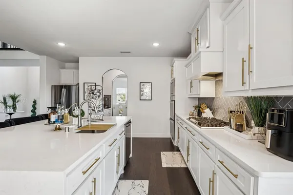 a kitchen with kitchen island white cabinets and white appliances