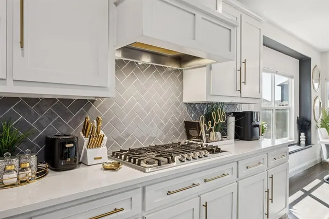 a kitchen with stainless steel appliances granite countertop a sink and cabinets