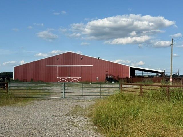 2-3 Fm 2815 Bonham, TX 75418 - Photo 7 of 11 Large red metal building featuring a white trim roof and sliding barn door