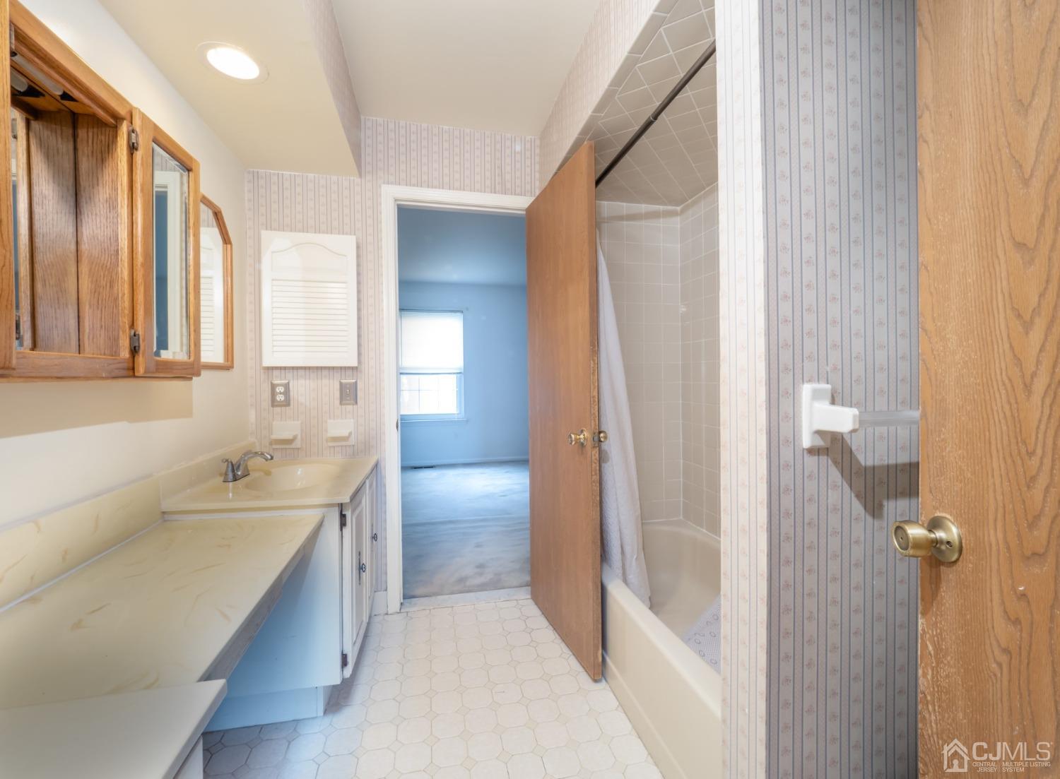 1403 Maplecrest Road Edison, NJ 08820 - Photo 23 of 23 a bathroom with a sink a toilet and shower
