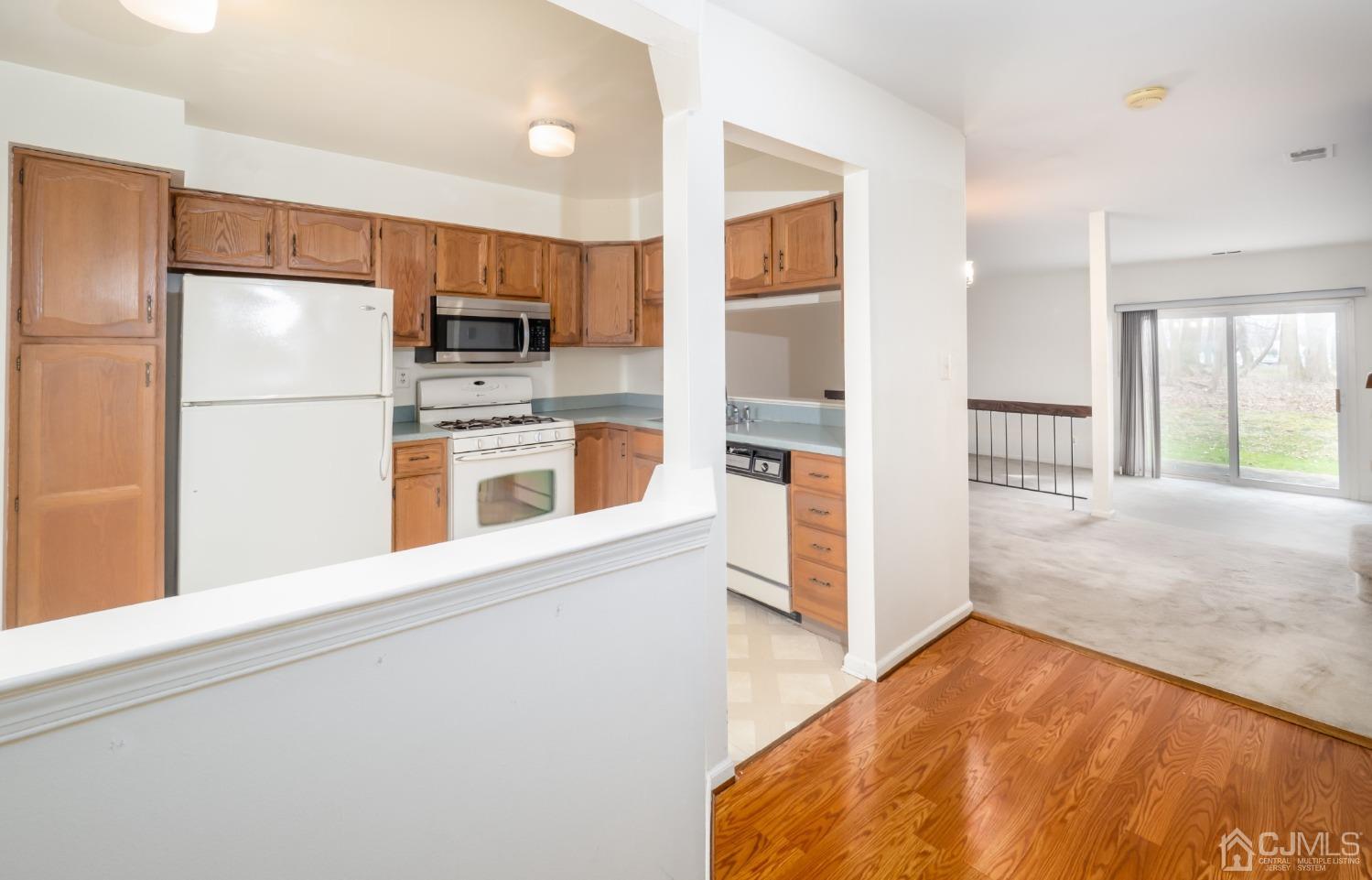 1403 Maplecrest Road Edison, NJ 08820 - Photo 3 of 23 a kitchen with a refrigerator and a stove top oven
