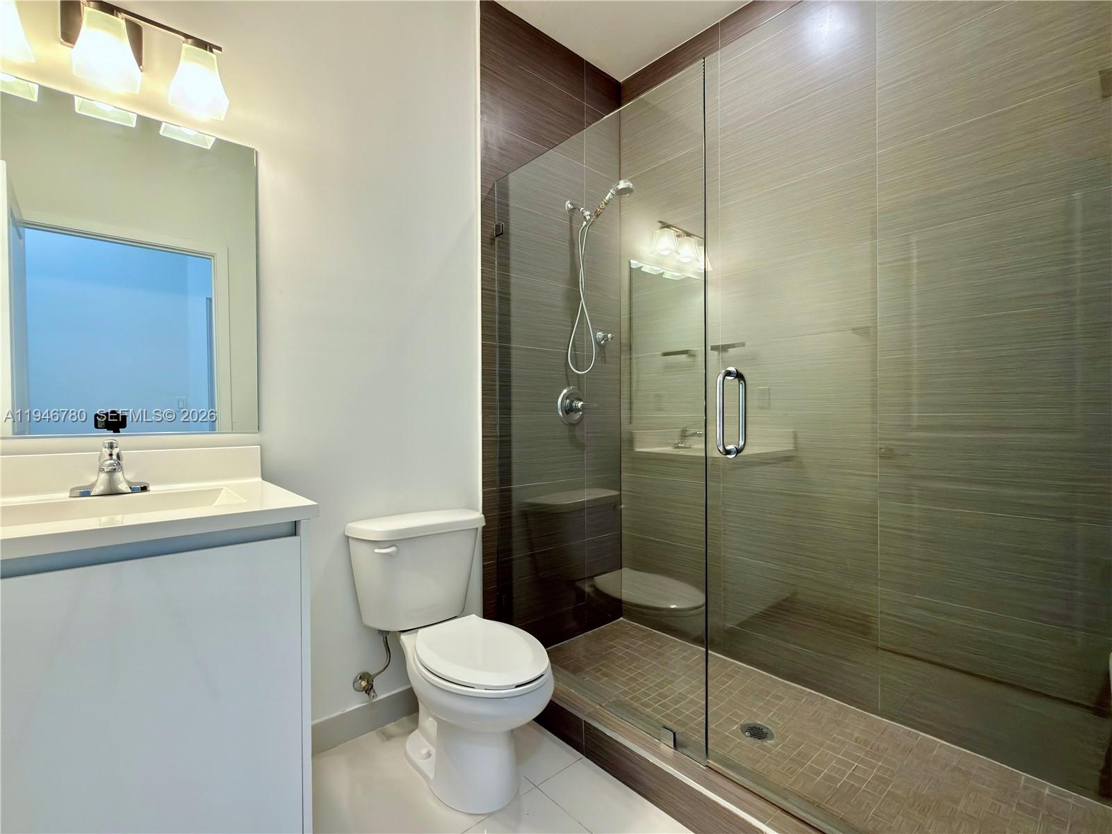 404 Southwest 91st Court Miami, FL 33174 - Photo 13 of 21 a bathroom with a shower a toilet a sink and mirror