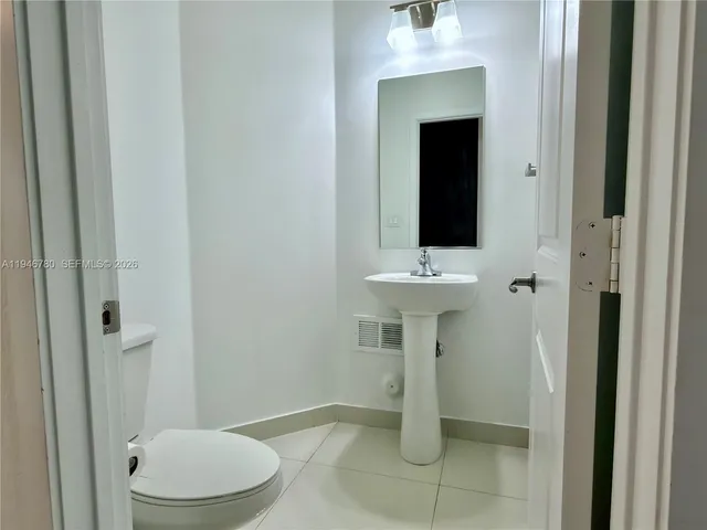 a bathroom with a toilet sink and shower