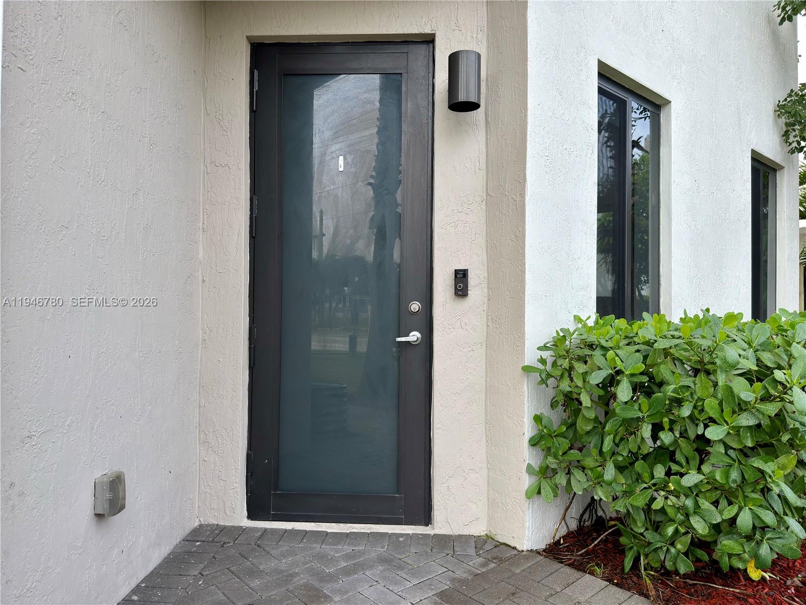 404 Southwest 91st Court Miami, FL 33174 - Photo 3 of 21 a view of a hallway with potted plants