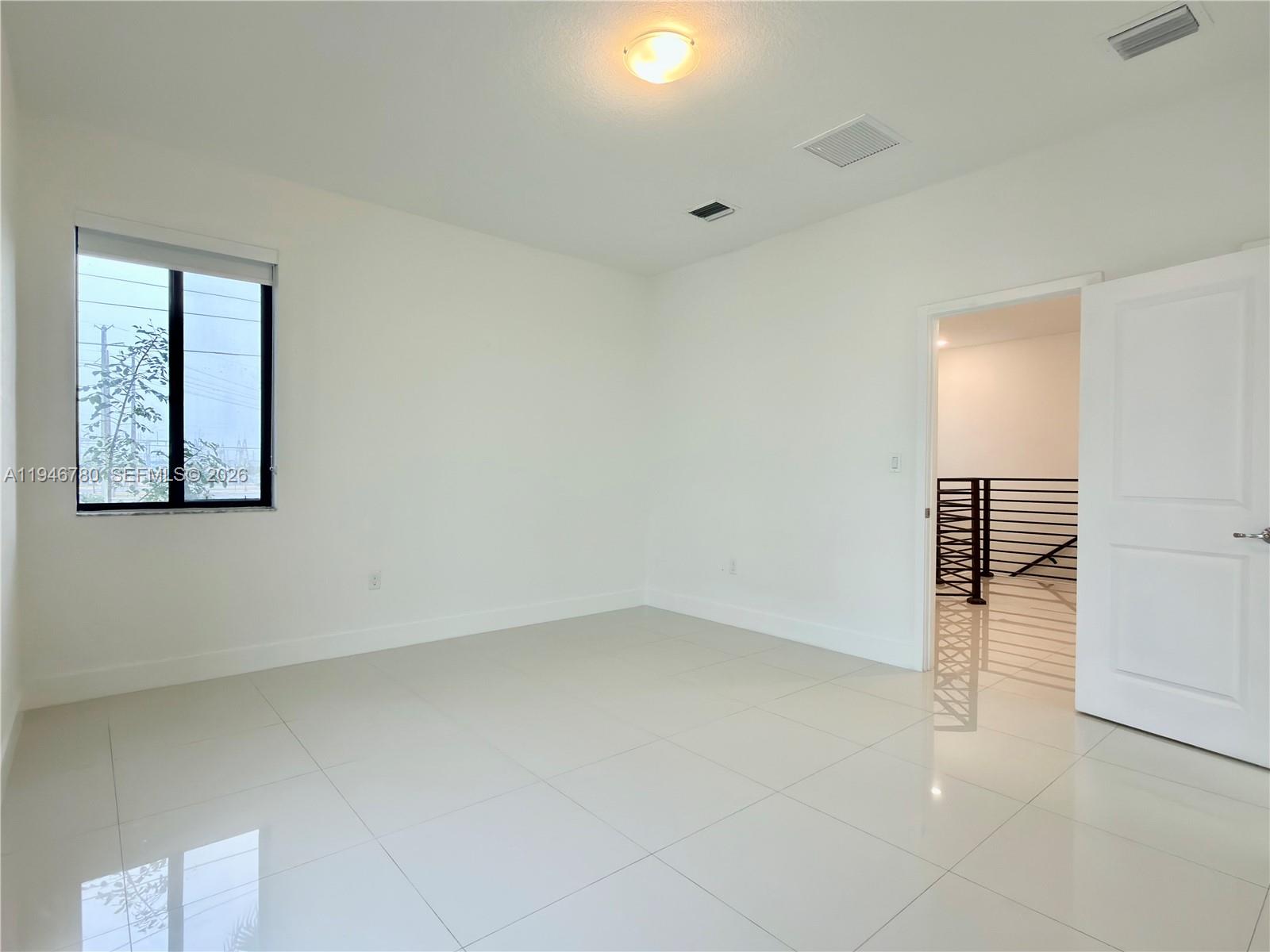 404 Southwest 91st Court Miami, FL 33174 - Photo 7 of 21 wooden floor in an empty room with a window