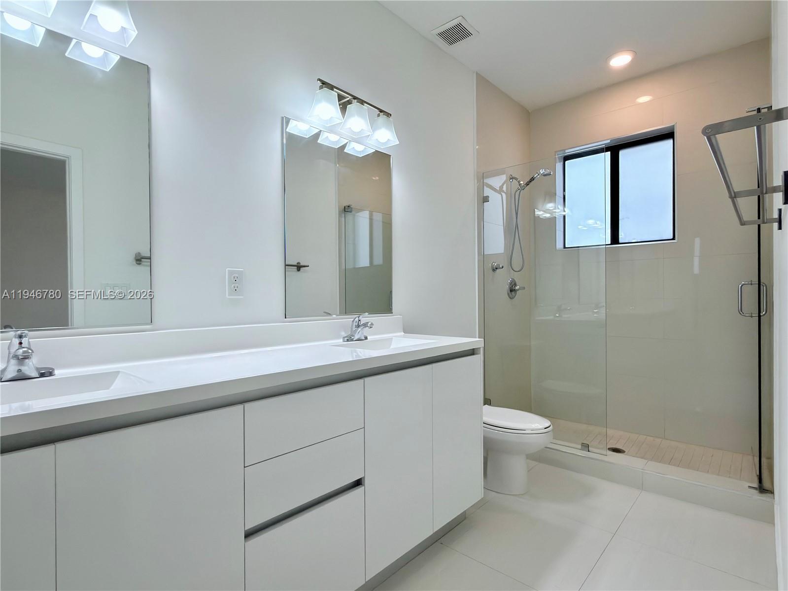 404 Southwest 91st Court Miami, FL 33174 - Photo 8 of 21 a bathroom with a double vanity sink toilet and shower
