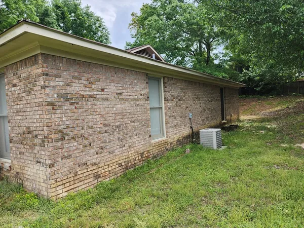 a backyard of a house with table and chairs