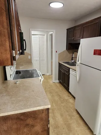 a kitchen with a refrigerator sink and stove