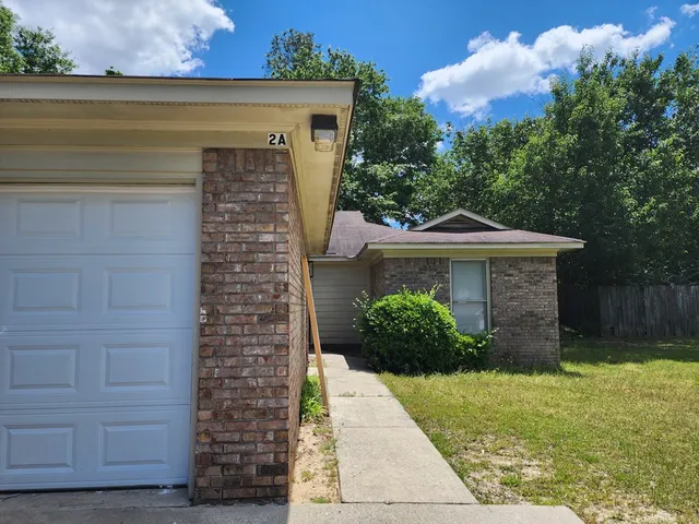 a front view of a house with plants