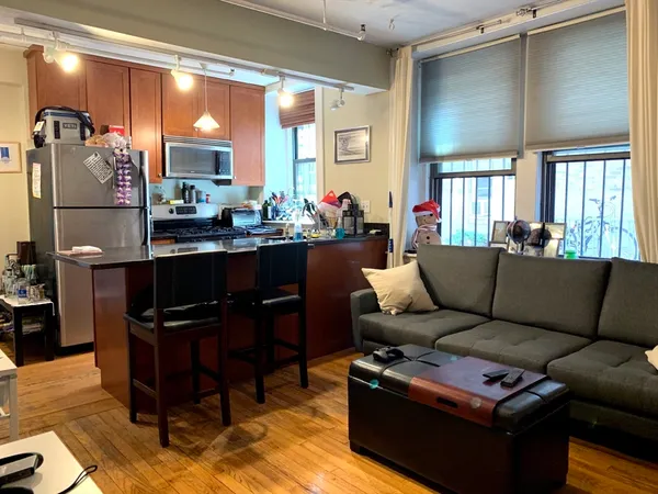 a living room with furniture a large window and a table