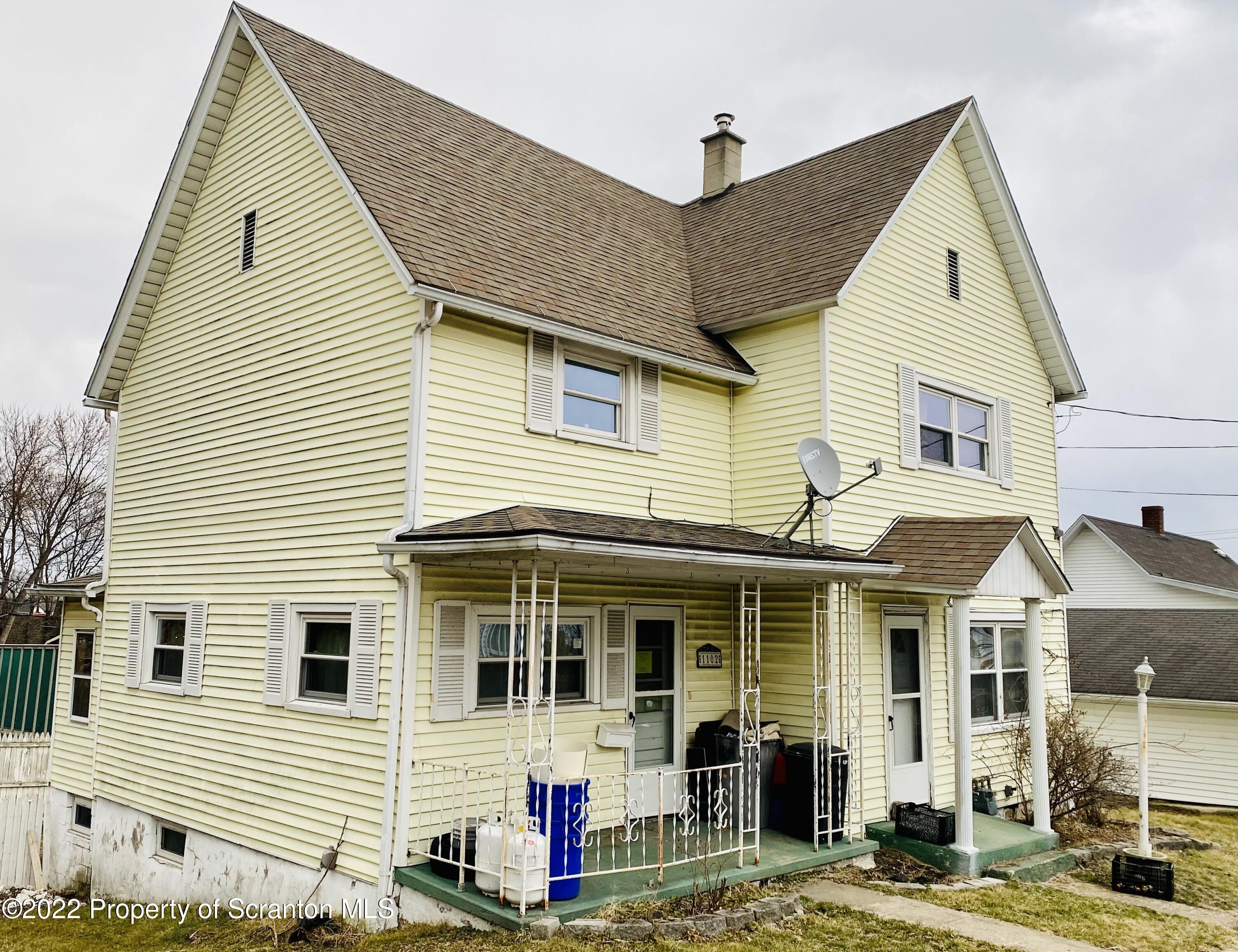 a view of a white house with large windows