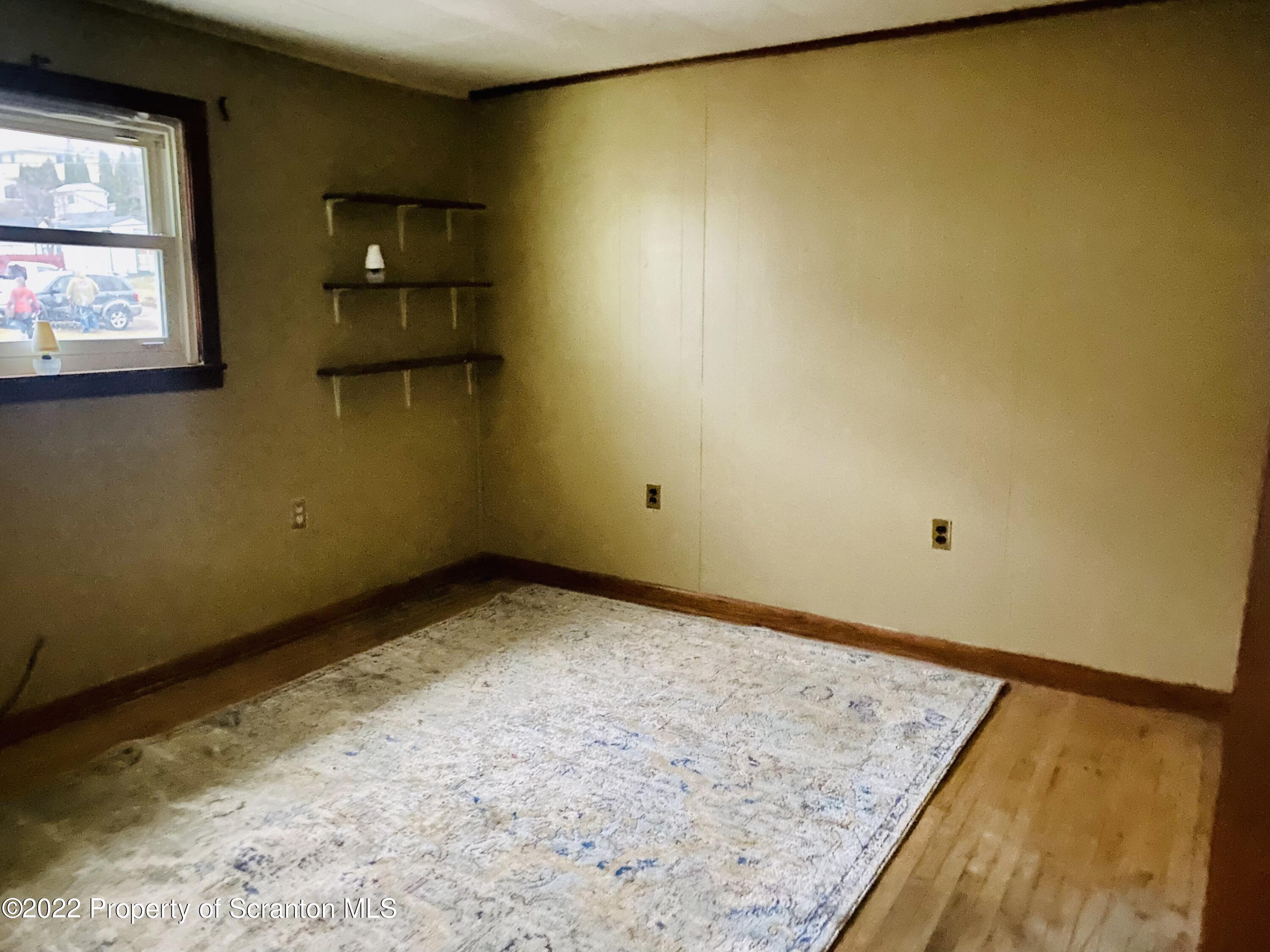 1102 Pierce Street Scranton, PA 18508 - Photo 7 of 10 a view of a room with a wooden floor and next to a window