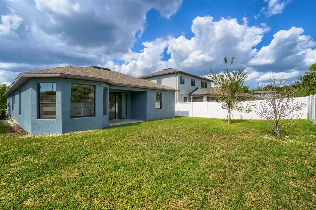 12690 Vander Way New Port Richey, FL 34654 - Photo 21 of 22 a view of a white house with a large garden