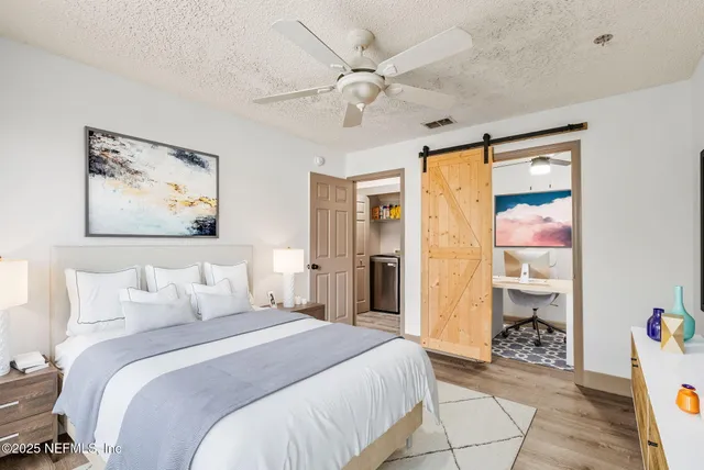 a bedroom with a bed and a chandelier