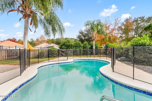 a view of a backyard with swimming pool