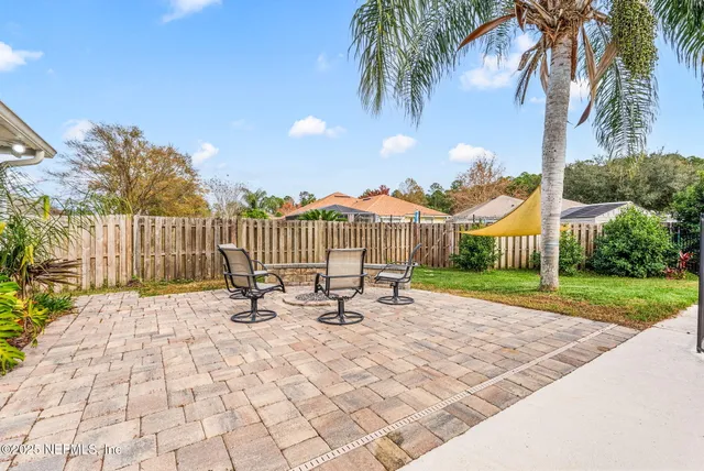 a view of a patio with a table and chairs