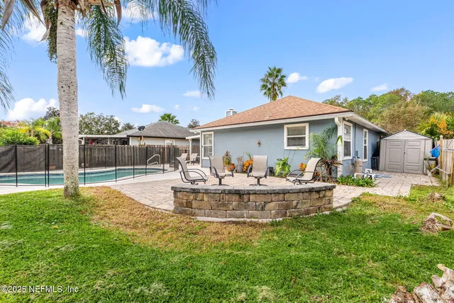 a front view of a house with swimming pool having outdoor seating