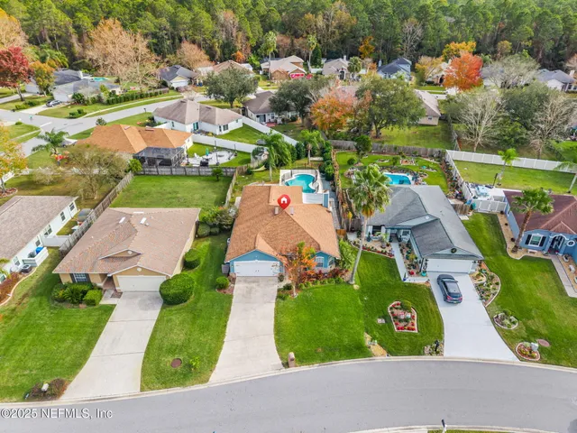 an aerial view of residential houses with outdoor space and street view
