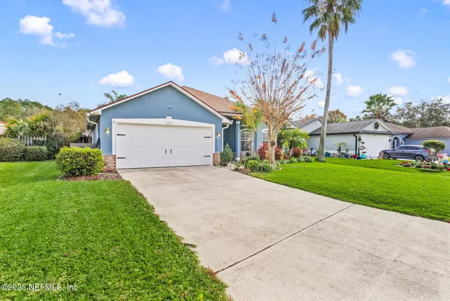 a front view of house with yard and green space