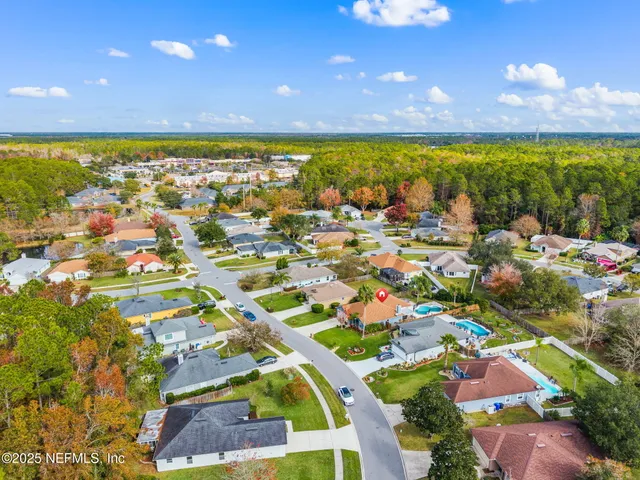 an aerial view of residential building with outdoor space and swimming pool