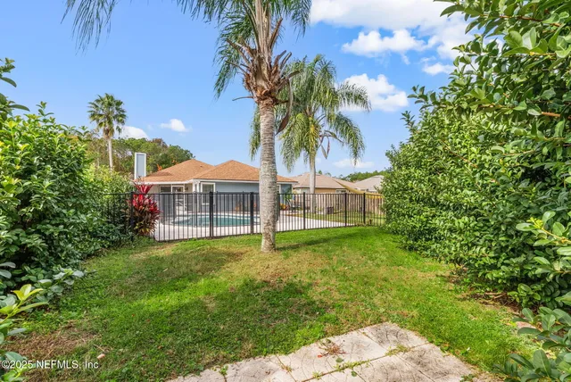 a view of a garden with a house