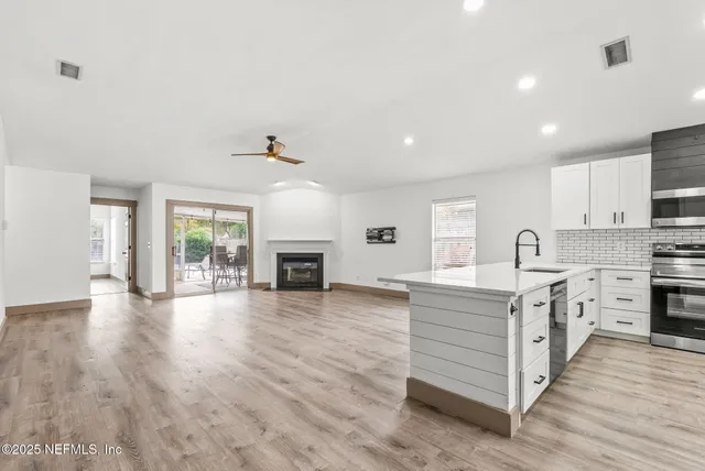 a view of kitchen with sink and wooden floor
