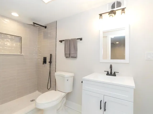 a bathroom with a toilet sink and shower