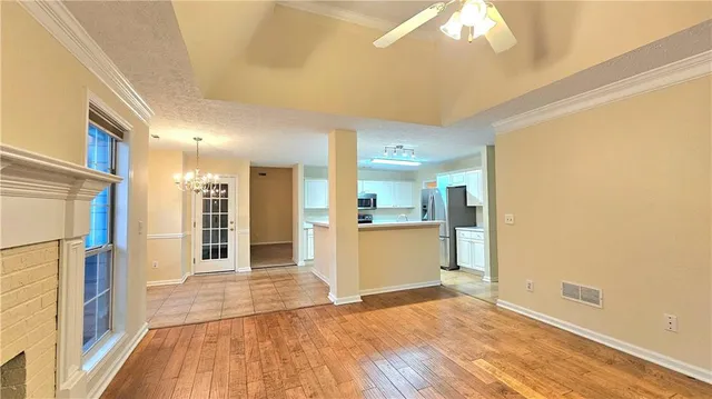 a view of a kitchen with a sink and a refrigerator