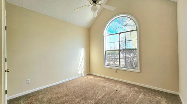 an empty room with windows and closet
