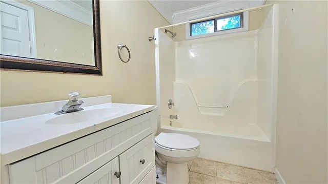 a bathroom with a sink toilet vanity and shower