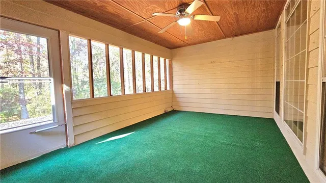 a view of a room with window and a ceiling fan